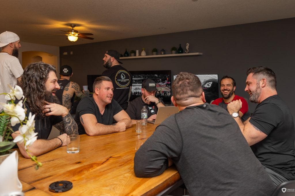 A group of men engaged in deep conversation at an Uncaged Men’s Accountability Group gathering, emphasizing commitment, accountability, and personal growth.