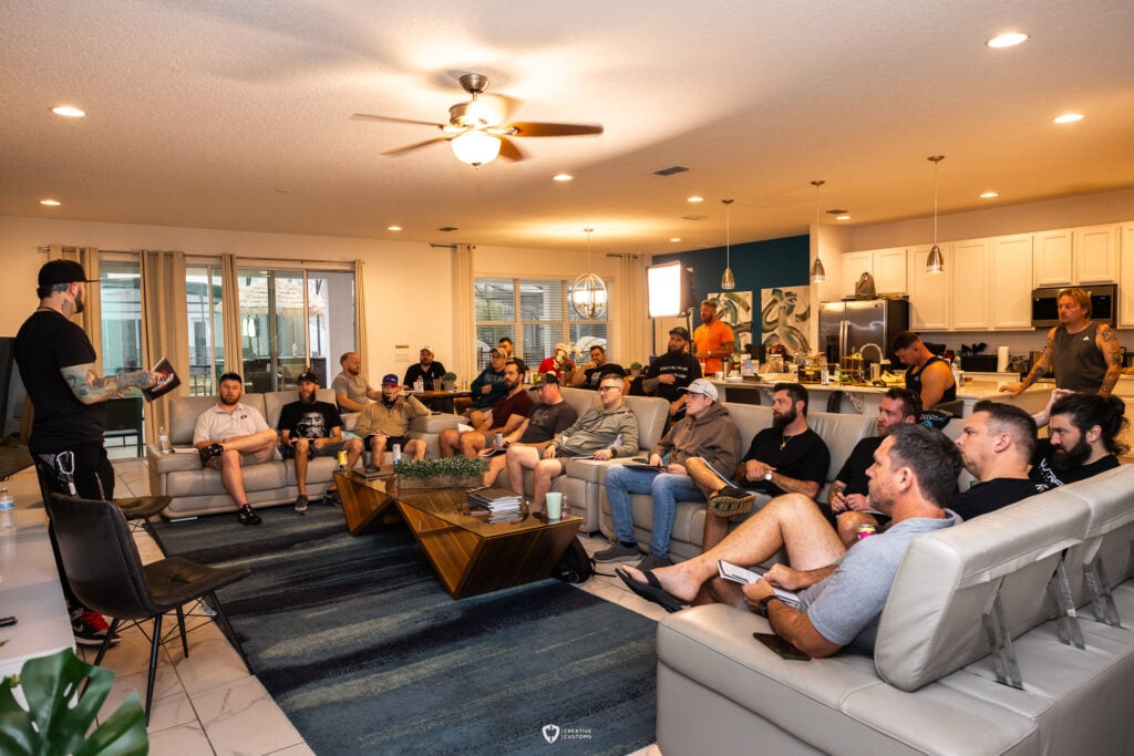 Men gathered in a living room for a powerful discussion on overcoming past traumas and achieving personal growth at an Uncaged Men’s Accountability Group retreat.