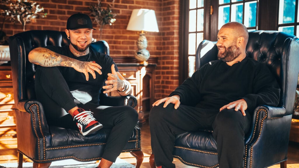 Zack Williams in a deep discussion with a guest, sharing insights on success, mindset, and accountability at an Uncaged Men’s Accountability Group session.