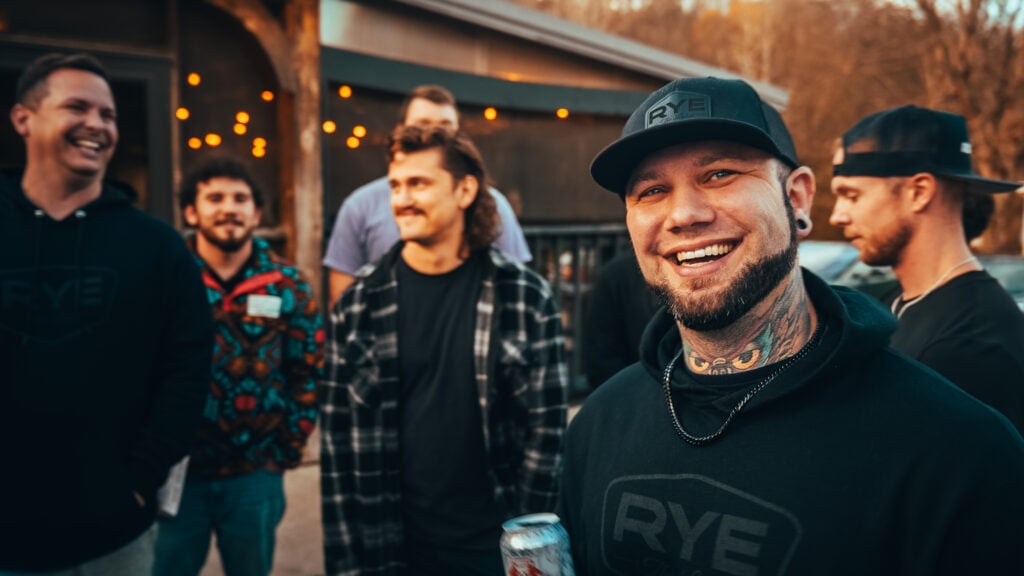 A group of men laughing and connecting at an Uncaged Men’s Accountability Group event, embracing vulnerability and the power of brotherhood.