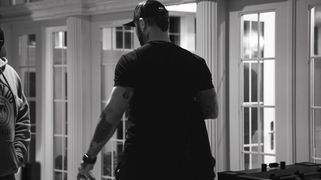 A black-and-white image of Zack Williams at an Uncaged Men’s Accountability Group event, symbolizing discipline, resilience, and the commitment to long-term success.