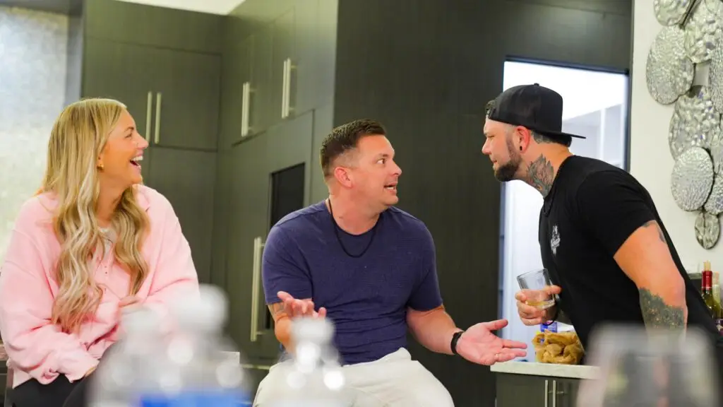Zack Williams engaging in a deep conversation at an Uncaged event, challenging men to take action toward their dream life.
