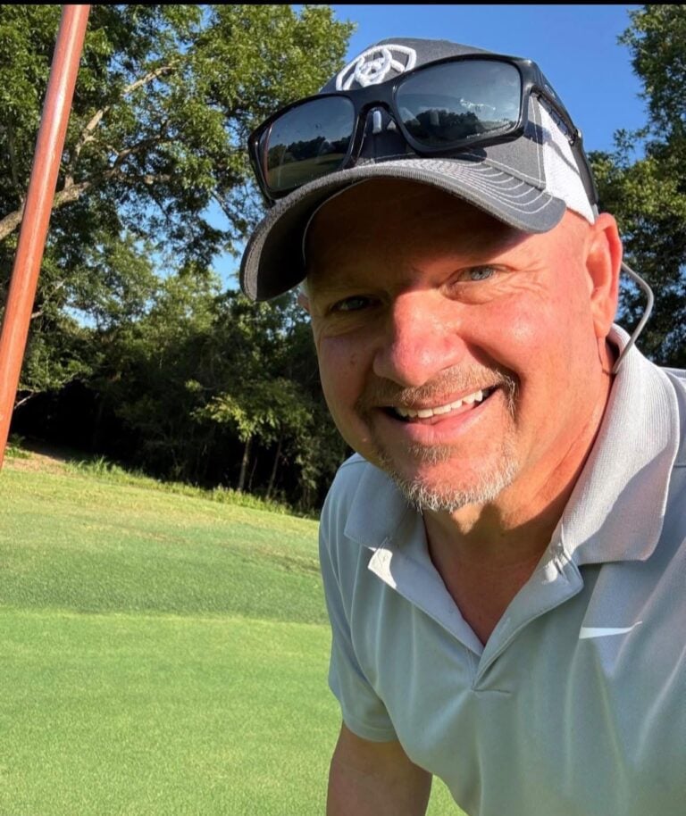 Kevin Faulkner smiling on a golf course, representing authenticity, discipline, and community-driven growth through the Uncaged Men’s Only Accountability Group.