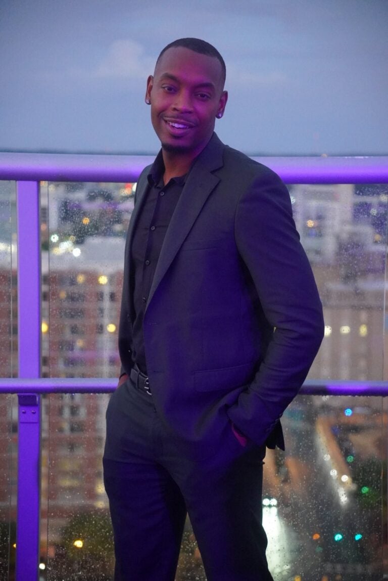Clayton Shivers dressed in a suit, symbolizing confidence, brotherhood, and personal growth through accountability in the Uncaged Men’s Only Accountability Group.
