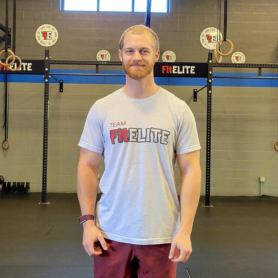 Korey Jacobson standing in a gym, representing personal growth, discipline, and professional transformation through the Uncaged Men’s Only Accountability Group.